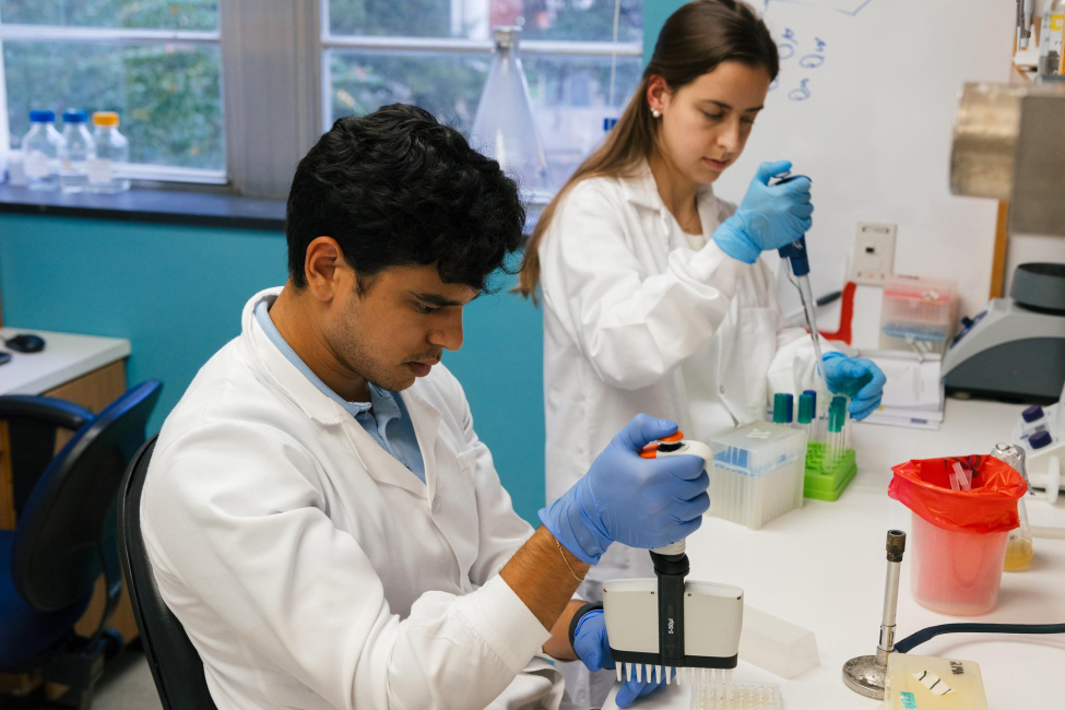 Two laboratory technicians at Baylor College of Medicine prepare samples to isolate DNA for sequencing. (Photo courtesy of TEPHI/Texas Epidemic Public Health Institute)